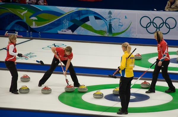 ilustrasi permainan curling saat peserta 'menggosok lantai'